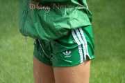 Watching sexy Sandra wearing a sexy green shiny nylon shorts and a green shiny nylon rain jacket enjoying the garden shower (Pics)