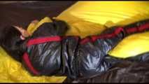 Lucy wearing a sexy black/red shiny nylon downsuit preparing her bed with nylon linen and enjoys it (Video)