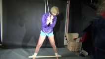 Watching sexy Pia wearing a sexy lightblue shiny nylon shorts and a purple rain jacket being tied and gagged with ropes and a ball gag overhead (Video)