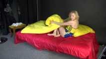 *** Sexy MIA wearing a blue shiny nylon shorts and a yellow top during changing the cloths on her bed  (Video)***