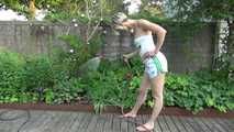 Sexy Sonja wearing a *white* shiny nylon shorts with a white top durig watering the garden (Video)