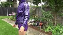 Watching Aiyana wearing a sexy purple shiny nylon shorts and a purple rain jacket while taking a shower in the garden (Video)