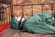 Pia tied, gagged and hooded in a princess bed wearing sexy shiny green rainwear (Pics)