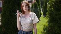 18 y.o. Sasha is smoking two white 120mm cigarettes outdoors