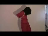 03:30 Min. video with Jessy tied in a shiny red rainsuit freeing herself