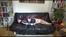 Mara tied and gagged on a sexy black covered sofa wearing a supersexy rain jacket and a adidas shorts (Video)