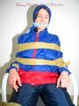 Katharina tied by using tape, gagged and hooded on a chair wearing sexy red/blue rainwear (Pics)