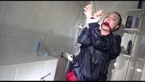 Jill tied and gagged taking a shower wearing sexy shiny nylon shorts and a rain jacket (Video)