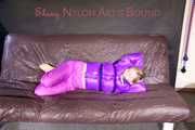 *** HOT HOT HOT*** NEW MODELL*** SANDRA wearing a sexy transparent purple shiny nylon pants and a purple down jacket tied and gagged on a sofa with ropes hand to feet and a cloth gag (Pics)