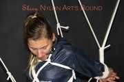 Sexy Sandra being tied and gagged overhead with ropes and a ballgag wearing a sexy blue rain pants and a rain jacket (Pics)